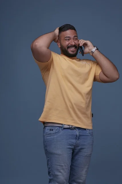 Smiling Saudi Man Talking on Phone in Casual Wear