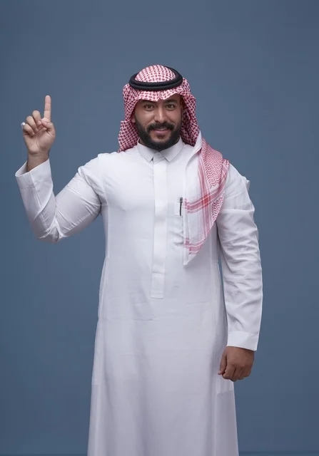 Saudi Man in Traditional Thobe and Shemagh Pointing Upward