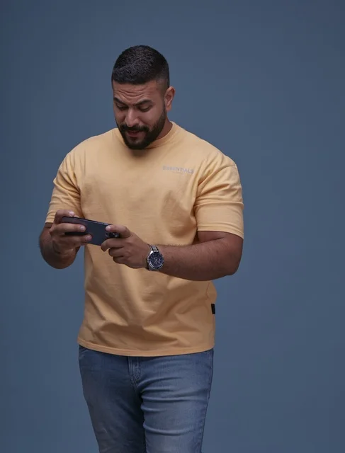 Saudi Man Playing Mobile Game on Smartphone in Studio