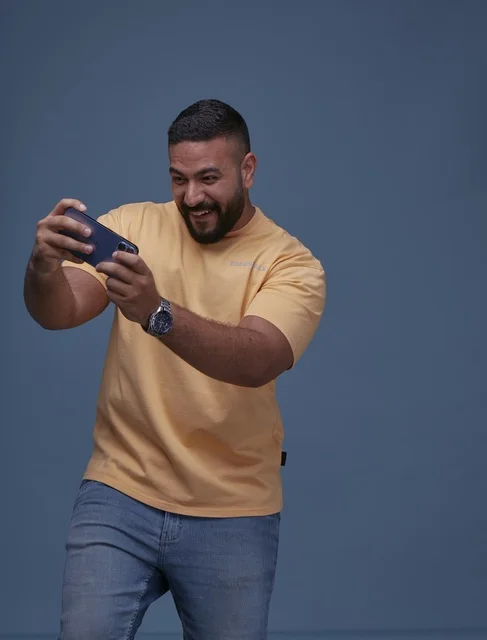 Saudi Man Playing Mobile Games in Studio