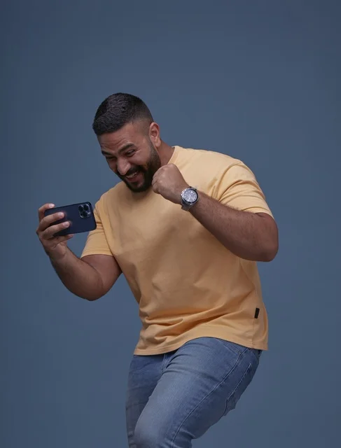 Casual Saudi Man Playing on Smartphone