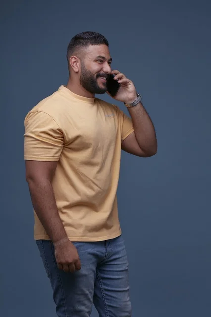 Smiling Saudi Man Talking on Smartphone in Studio