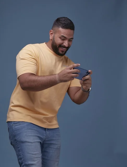 Saudi Man Playing Mobile Games on Smartphone