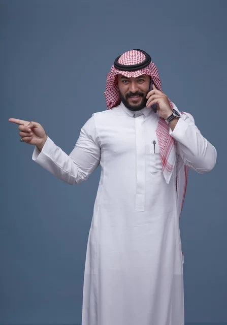Saudi Man Talking on Smartphone and Pointing