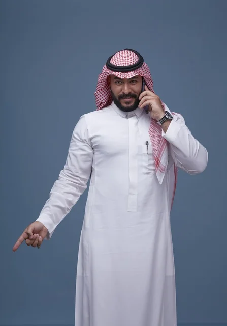 Saudi Man Using Smartphone and Pointing Downwards Studio