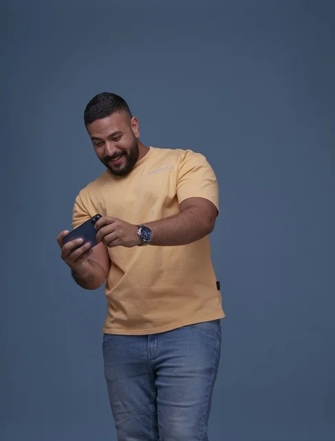 Saudi Man Playing Mobile Game on Smartphone