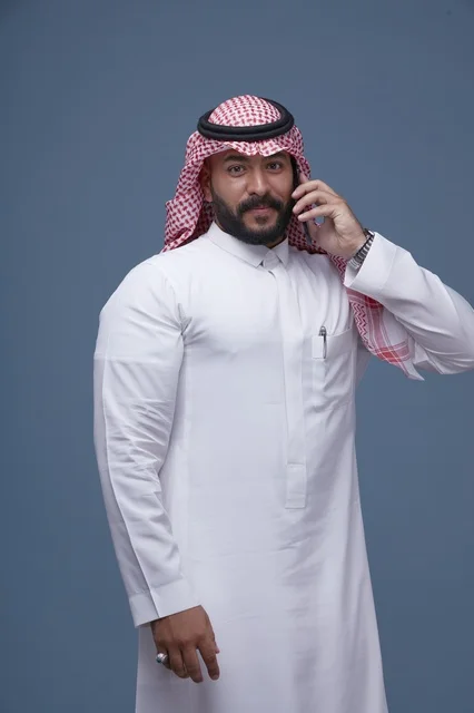 Smiling Saudi Man Talking on Smartphone in Studio