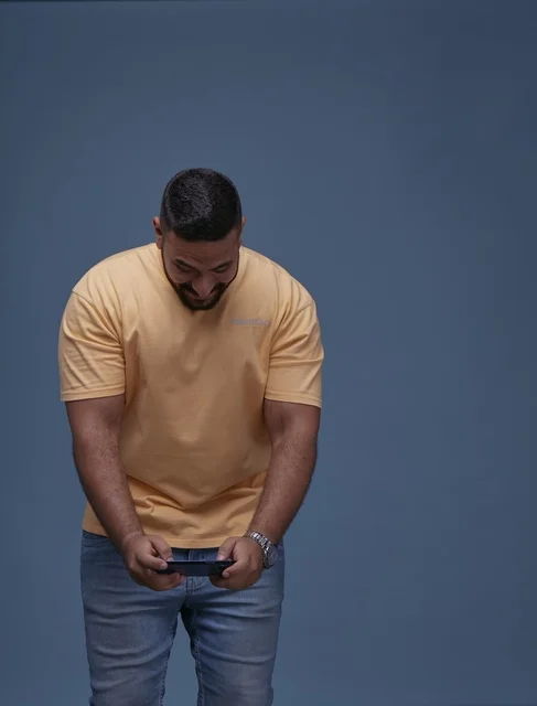 Young Saudi Man Playing Mobile Game on Smartphone