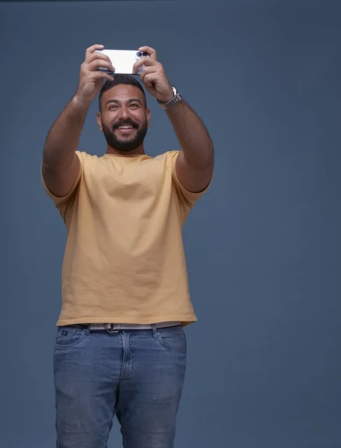Saudi Man in Casual Clothes Using Smartphone Gaming