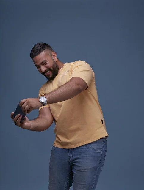 Saudi Man Playing Mobile Game on Smartphone in Studio