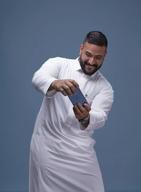 Saudi Man Playing Mobile Game on Smartphone
