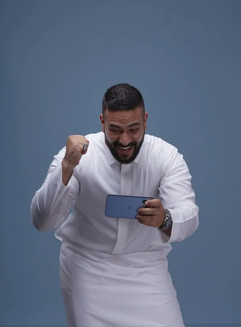 Saudi Man Playing Mobile Games on Smartphone