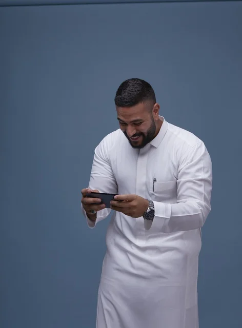 Saudi Man Using Smartphone for Mobile Gaming