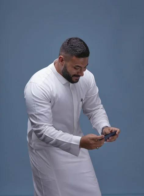 Saudi Man Mobile Gaming on Smartphone Studio Shot