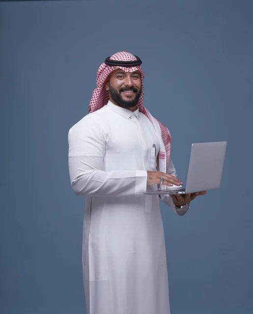 Saudi Businessman with Laptop in Traditional Dress