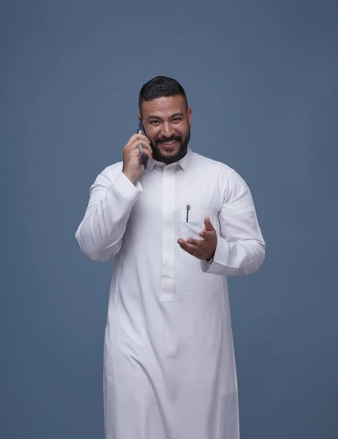 Saudi Man in Thobe Talking on Smartphone Studio Shot
