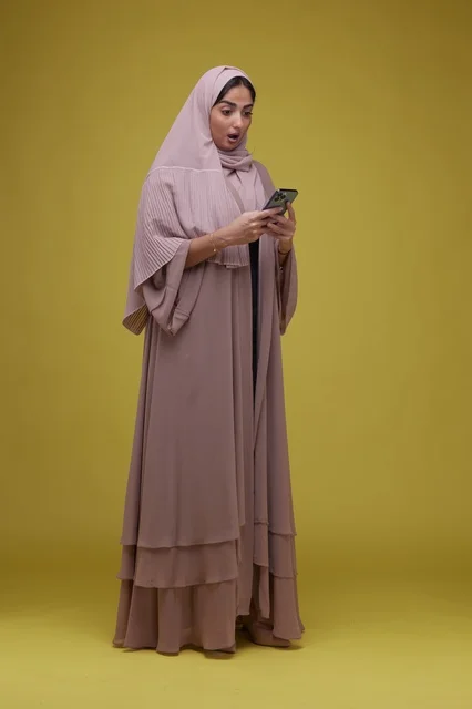 Saudi Woman with Smartphone Surprised in Studio