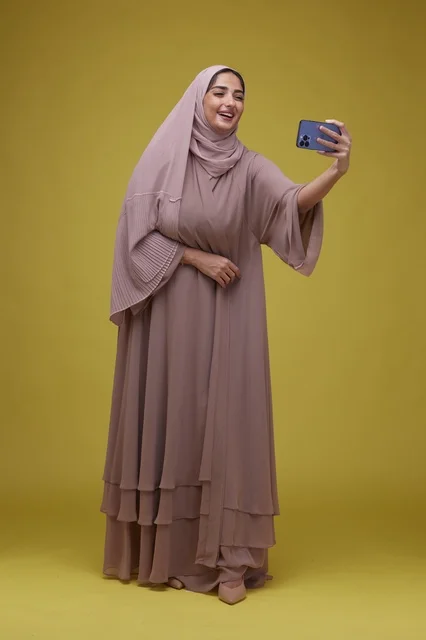 Saudi Woman Taking Selfie in Studio Setting