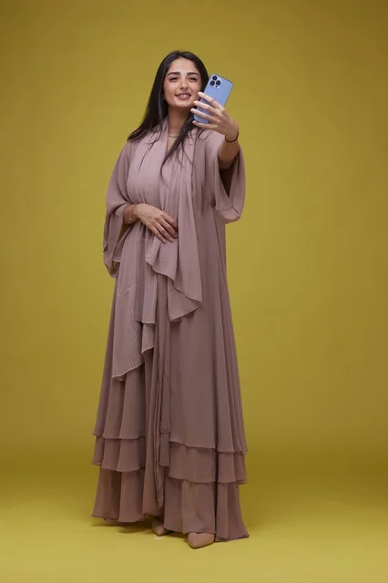 Saudi Woman Taking Selfie on Yellow Background