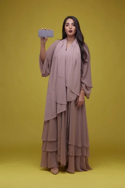 Saudi Woman Holding Smartphone on Yellow Background