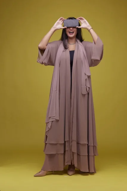 Saudi Woman with Smartphone on Yellow Background