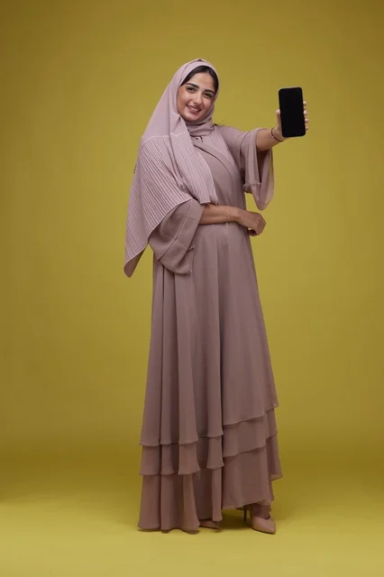 Saudi Woman with Hijab Holding Blank Smartphone Screen