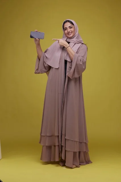 Saudi Woman Pointing at Blank Smartphone Screen Mockup