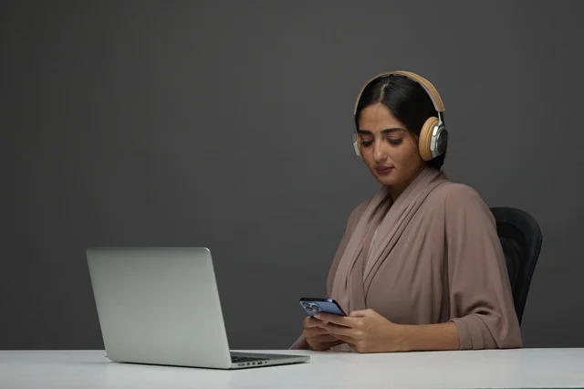 Saudi Woman with Laptop and Headphones in Studio