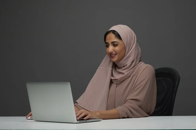 Saudi Professional Woman Working on Laptop in Office