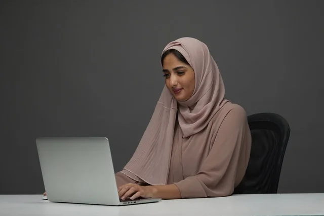 Saudi Businesswoman Working on Laptop at Modern Office