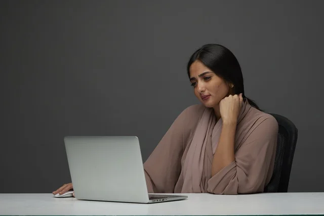 Saudi Businesswoman Working on Laptop in Modern Office