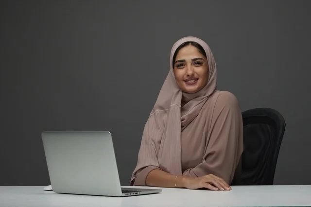 Saudi Businesswoman with Laptop at Office Desk