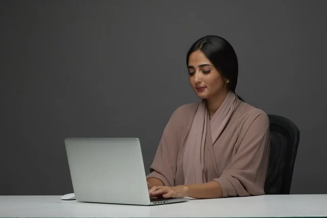 Saudi Businesswoman Working on Laptop in Modern Office