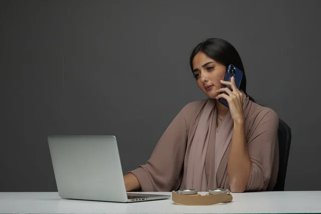Saudi Businesswoman Working on Laptop and Smartphone Saudi Businesswoman Working on Laptop and Smartphone
