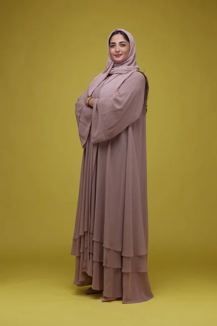 Full Length Saudi Woman in Mauve Abaya on Yellow Background