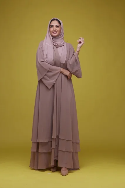 Saudi Woman in Mauve Abaya on Yellow Background