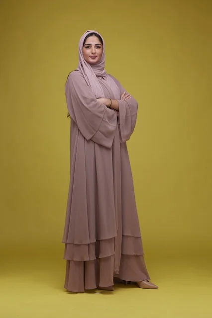 Saudi Woman in Mauve Abaya on Yellow Background