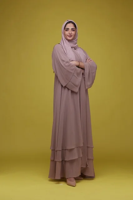Saudi Woman in Mauve Abaya on Yellow Background