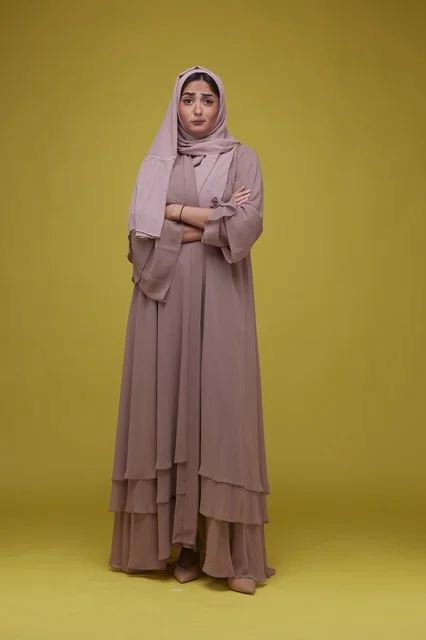 Saudi Woman in Pink Abaya Yellow Background