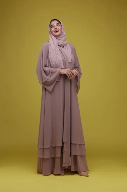 Saudi Woman in Mauve Abaya on Yellow Background