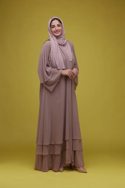 Saudi Woman in Mauve Abaya on Yellow Background
