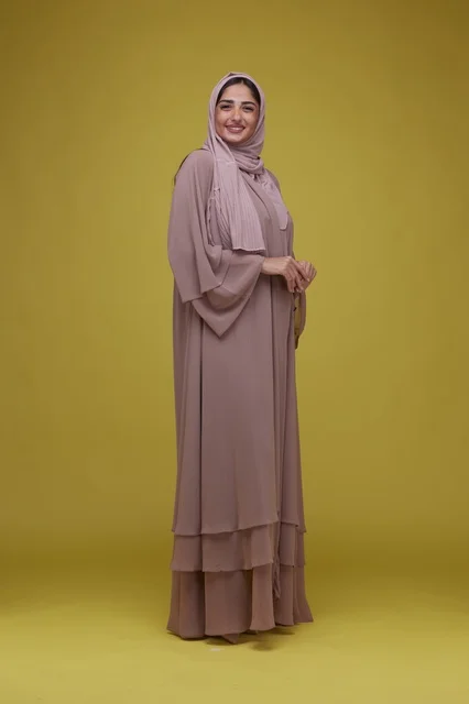 Saudi Woman in Mauve Abaya on Yellow Background