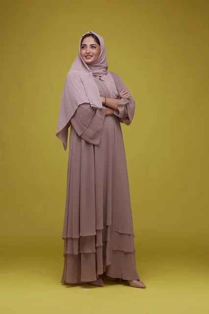 Saudi Woman Wearing Mauve Abaya on Yellow Background