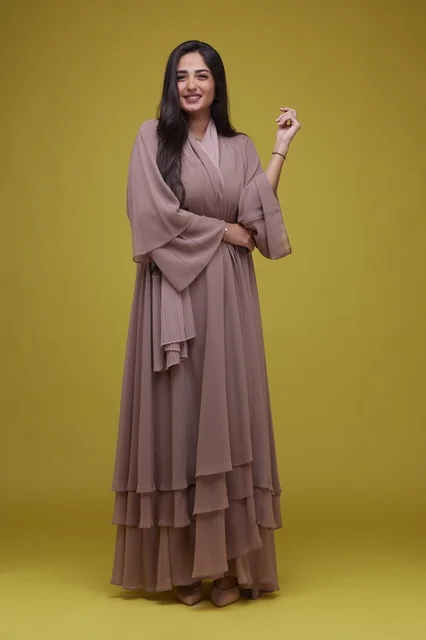 Saudi Woman in Mauve Abaya on Yellow Background