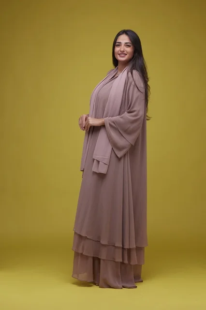 Saudi Woman in Mauve Abaya on Yellow Background