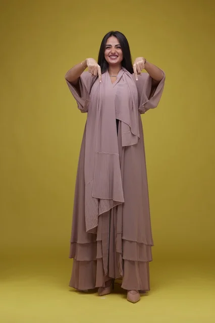 Saudi Woman Pointing Down in Modern Abaya