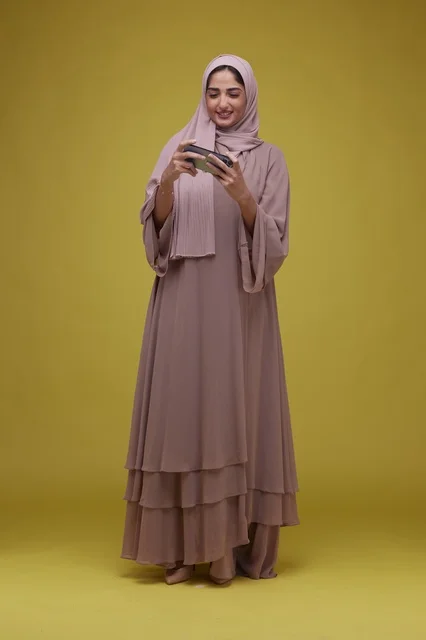 Saudi Woman Playing Mobile Game on Smartphone