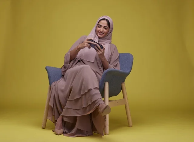 Saudi Woman Playing Mobile Game on Smartphone