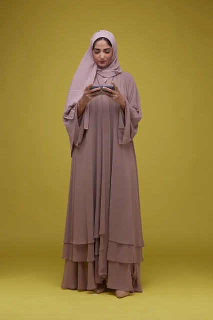 Young Saudi Woman Playing Game on Smartphone
