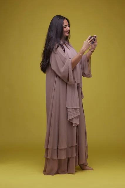 Saudi Woman Playing Mobile Game on Smartphone